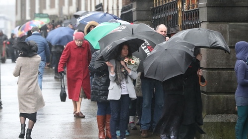 People queued outside the church to file past the open coffin and pay their respects