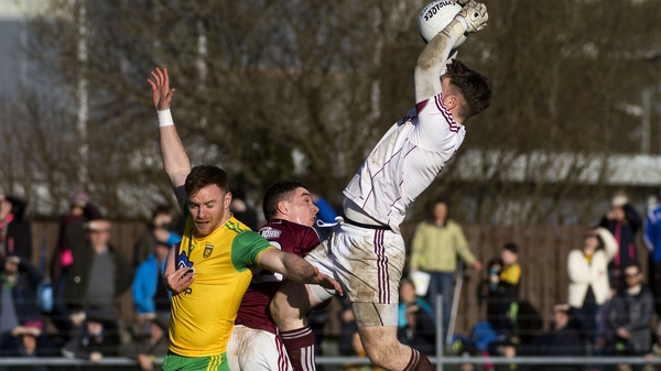 Galway goalkeeper Ruairí Lavelle fields a high one over Donegal's Eamonn Doherty