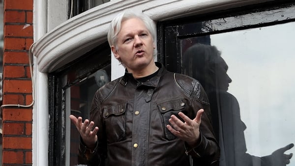 Julian Assange, seen here on a balcony of the embassy in 2018, has been inside the building since 2012
