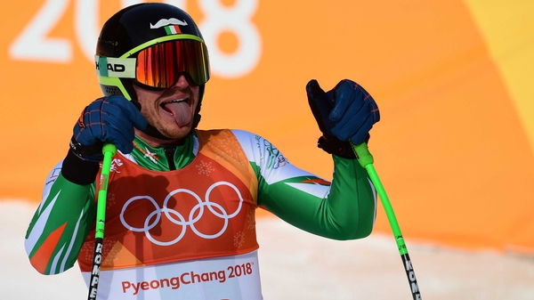 Ireland's Patrick McMillan reacts after crossing the finish line of the men's downhill at the Winter Games