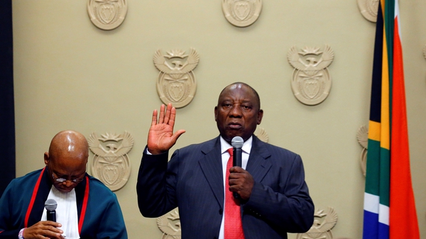 Cyril Ramaphosa (R) is sworn into office by South Africa's Chief Justice Mogoeng Mogoeng