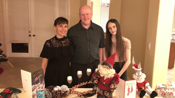 Olga Hurley (L) with her husband and daughter Adelina, who was in the school when the mass shooting occurred