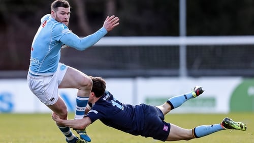 Garryowen's James McInerney is tackled by Rory Mulvihill of UCD