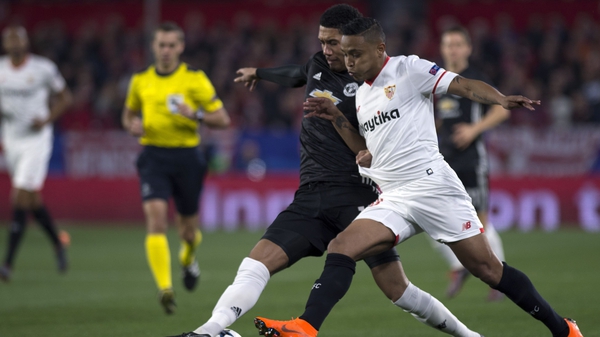 Chris Smalling (L) battles with Sevilla's Colombian forward Luis Muriel