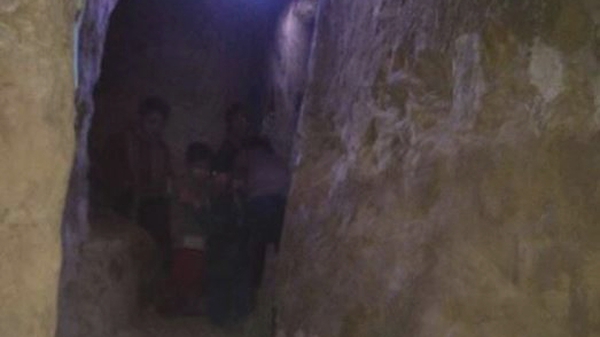 A family huddles in a bomb shelter in Eastern Ghouta (Pic: Women Now)