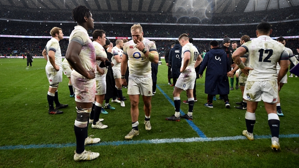 England players stand around dejected following the defeat at Twickenham
