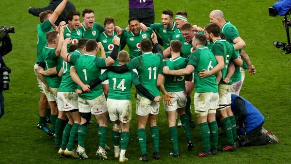 The Irish players celebrate at the final whistle at Twickenham