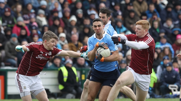 Galway's Sean Andy O'Ceallaigh and David Wynne tackle James McCarthy of Dublin