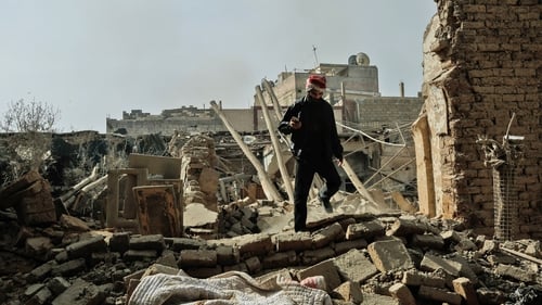 A man walks among the rubble following an air strike in Douma, Eastern Ghouta