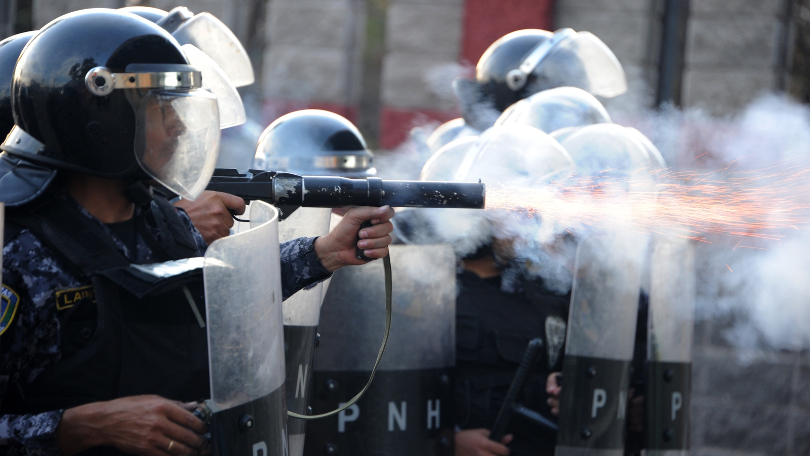 Image - Police use tear gas at students protesting after a killing in Honduras