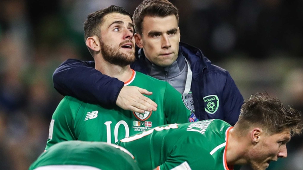 Seamus Coleman commiserates with Ireland players after the 5-1 loss to Denmark