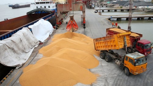 Soybeans imported to China are loaded onto a lorry at a