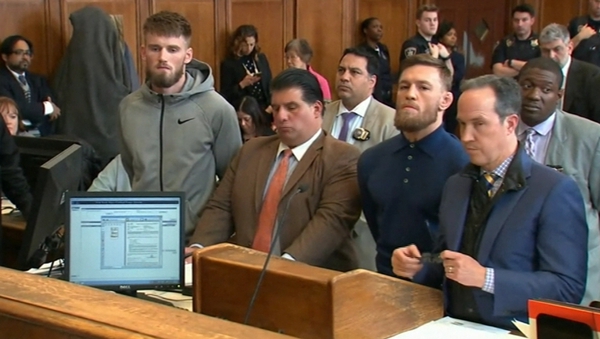 Conor McGregor (third from left) and fellow fighter Cian Cowley (far left) in court today