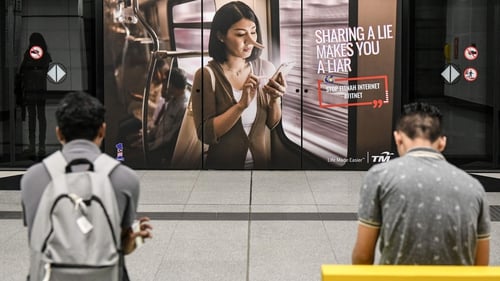 An anti-fake news advert from Telekom Malaysia in downtown Kuala Lumpur. Photo: Mohd Rasfan AFP/Getty Images