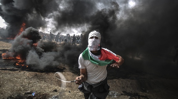 Palestinian protesters threw rocks and burned tyres near the Gaza-Israel border today