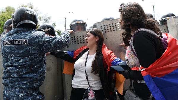Armenian police scuffle with opposition supporters during a rally in Yerevan today