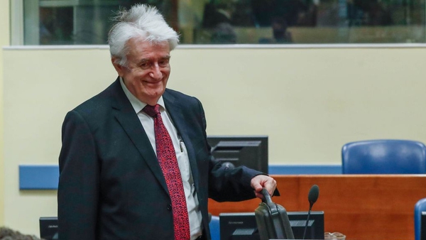 Radovan Karadzic arrives in a courtroom before the International Residual Mechanism for Criminal Tribunals