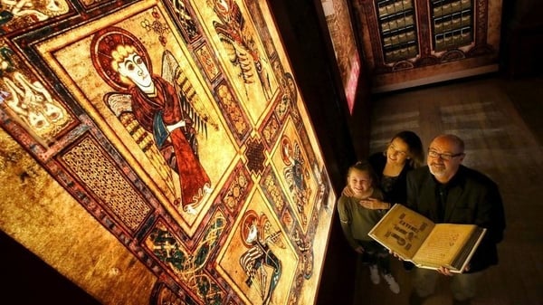 Author PJ Lynch with a page of the Book of Kells, enlarged for display.