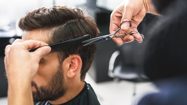 Barber using scissors and comb
