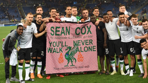 Liverpool players hold a tribute to Liverpool fan Sean Cox following the game at the Stadio Olimpico