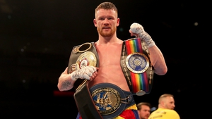 James Tennyson poses for pictures clad with three title belts after the fight