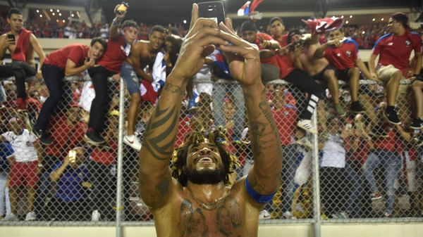 Roman Torres takes a selfie with the fans celebrating after he scored the goal that sent Panama to Russia