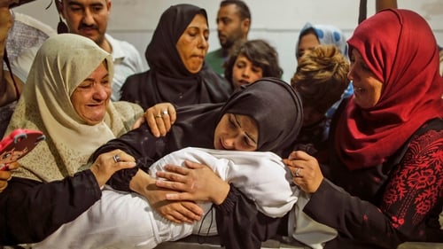 The mother of Leila al-Ghandour, the baby who died from tear gas inhalation, holds her at the morgue in Gaza