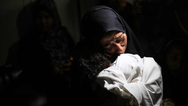 The mother of Leila al-Ghandour, the baby who died from tear gas inhalation, holds her at the morgue in Gaza. Photo: Getty Images