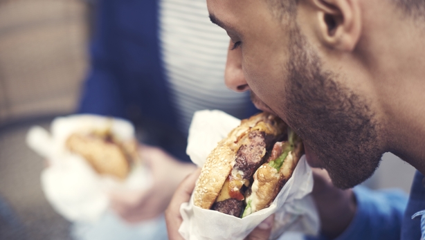 man eating burger