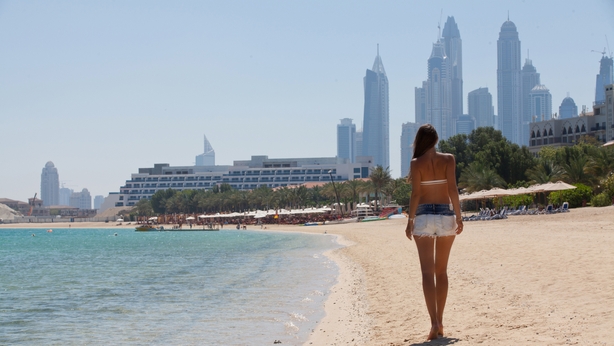 Summer vacation happiness carefree joyful woman walking on Dubai