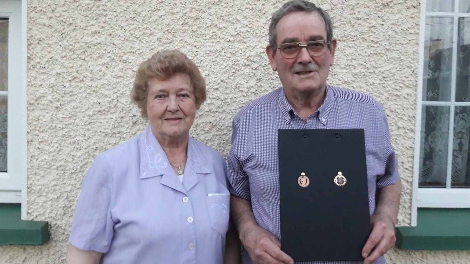 Image - Seamus Flynn and his wife Mary pose with two of his medals