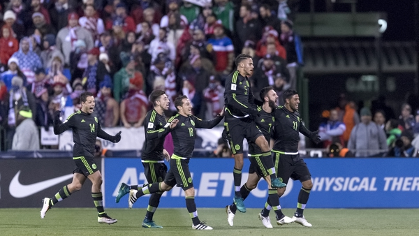 The Mexican players celebrate their late winner over the USA in a qualifier in Ohio
