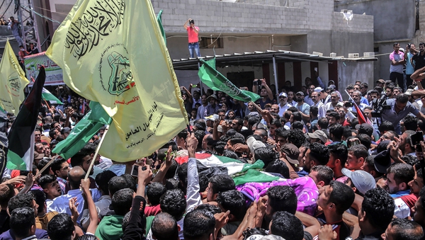 Palestinian mourners carry the body of nurse Razan al-Najar, 21, during her funeral in Khan Younis, southern Gaza Strip