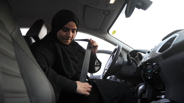 A Saudi woman puts on her seat belt as she begins a driving lesson in Riyadh