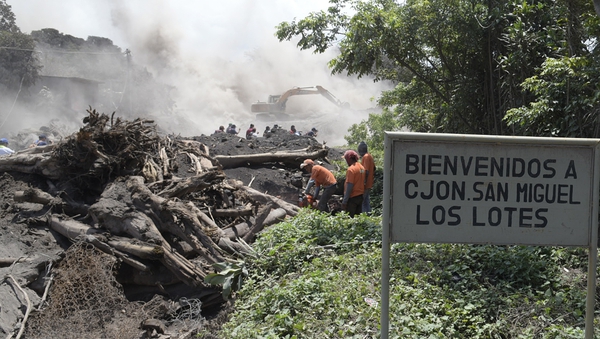 Rescuers search the tiny hamlet of San Miguel Los Lotes in Guatemala
