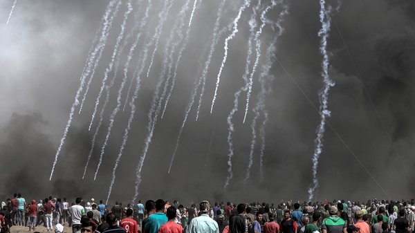 Israeli soldiers fire tear-gas at Palestinians protesters near the border with Israel, east of Gaza City, today