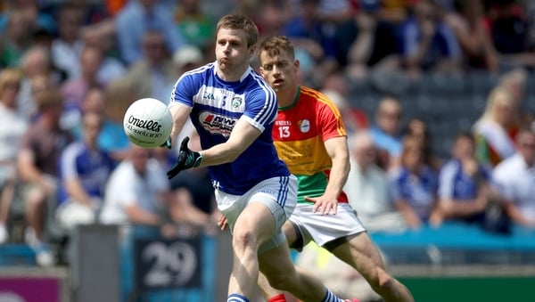 Laois' Mark Timmons gets the ball away despite the attention of Paul Broderick