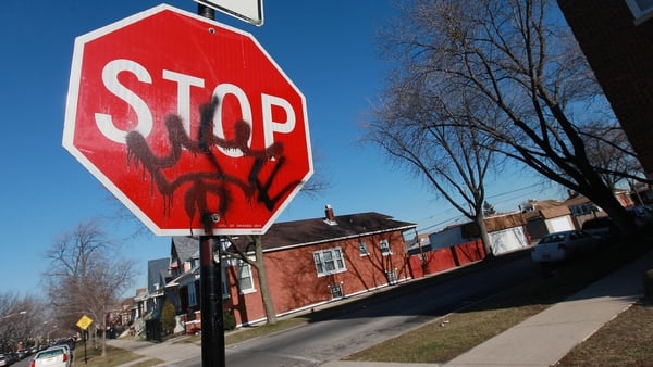 Gang graffiti on a road traffic sign