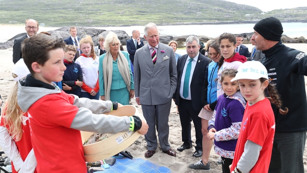 Charles and Camilla and Kevin 'Boxer' Moran (all centre), meet schoolchildren taking part in a project about plastic pollution on Derrynane beach, Co Kerry