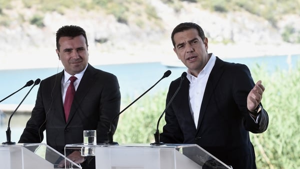 Greek Prime Minister Alexis Tsipras (R) and Macedonian Prime Minister Zoran Zaev speak prior to the signing ceremony