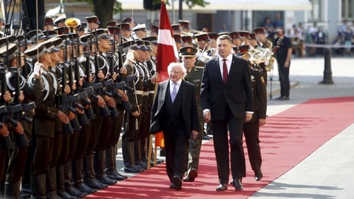President Michael D Higgins and Latvian President Raimonds Vejonis inspect a guard of honour during a welcoming ceremony in Riga