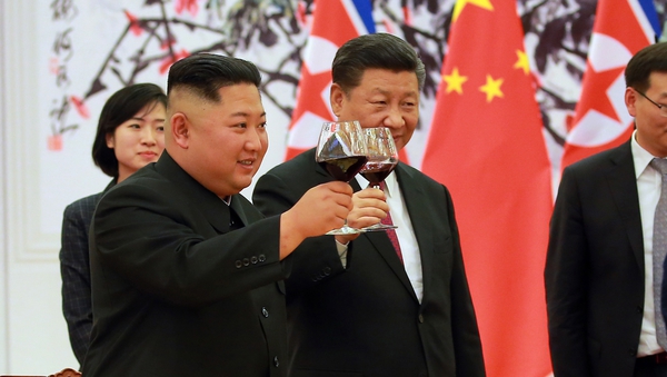 North Korean leader Kim Jong-un and Chinese President Xi Jinping make a toast at the Great Hall of the People in Beijing