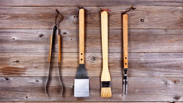 Used kitchenware for barbecue cooking on rustic wood