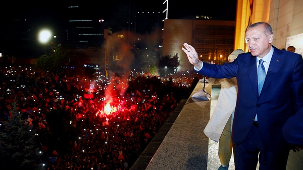 Recep Tayyip Erdogan greets the crowd from the balcony of the ruling AK Party's headquarters following his election win