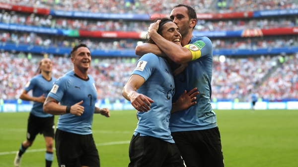 Diego Godin celebrates with Edinson Cavani while playing for Uruguay