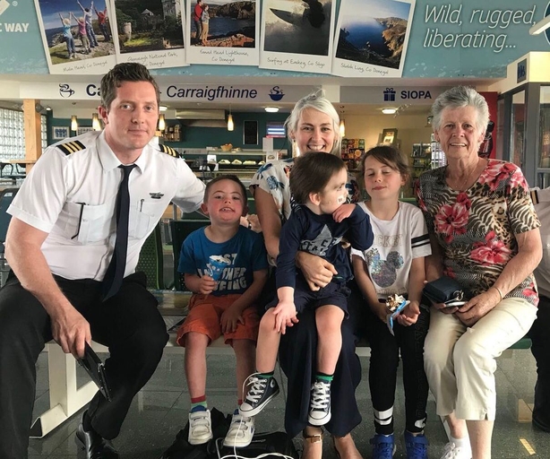 Oisin surrounded by his family at the airport