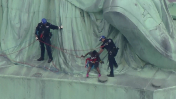 The woman accompanied police down off the monument after ther four-hour protest