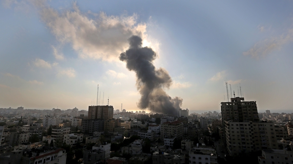Smoke rises from a building in Gaza following fire from an Israeli fighter jet