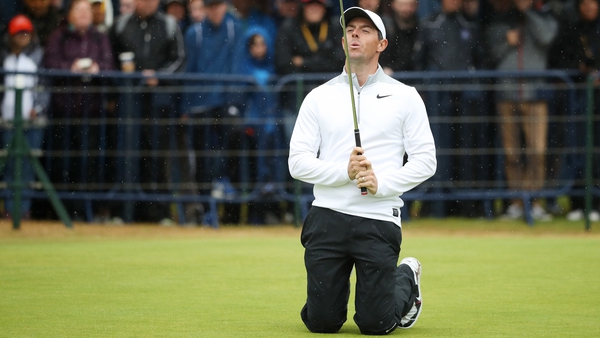 McIlroy reacts to a missed putt at the last
