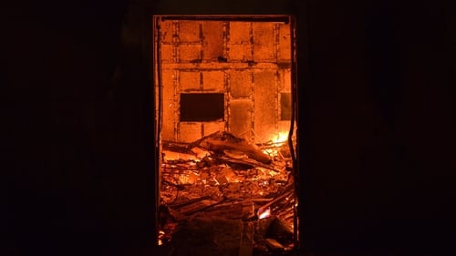 A house burns as a wildfire rages through the village of Mati, near Athens. Photo: Angelos Tzortzinis/AFP/Getty Images